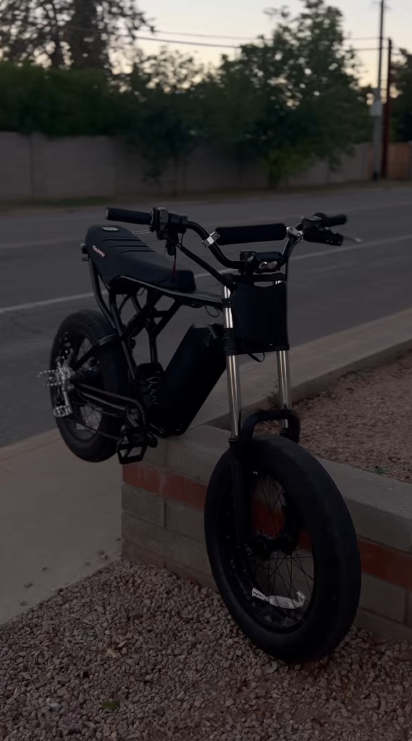 Custom black OMD e-bike parked at dusk